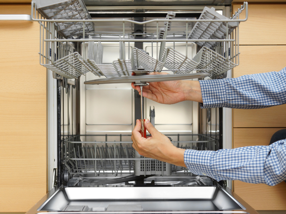 A Dishwasher being fixed by an appliance tech